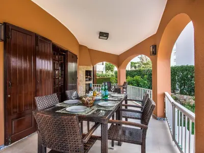 a patio with a table and chairs on a balcony at Villa Vera VIP Properties by Interhome in Vilamoura