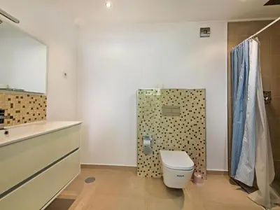 a bathroom with a toilet and a shower at Villa Nobre - VIP Properties by Interhome in Albufeira