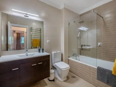 a bathroom with a toilet and a sink and a shower at Apartment T2 Cassias VIP Properties by Interhome in Vilamoura