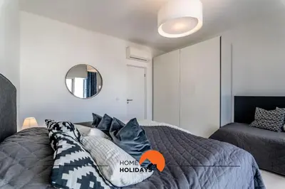 a bedroom with a bed and a mirror at #220 Windmill Hill by Home Holidays in Albufeira