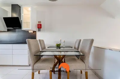 a dining room with a glass table and chairs at #220 Windmill Hill by Home Holidays in Albufeira