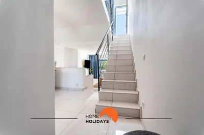 a staircase in a house with an orange arrow pointing to home holidays at #220 Windmill Hill by Home Holidays in Albufeira