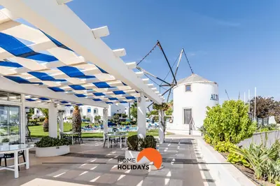 a view of a patio with a windmill in the background at #220 Windmill Hill by Home Holidays in Albufeira