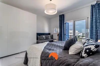 a bedroom with a bed with pillows and a window at #220 Windmill Hill by Home Holidays in Albufeira