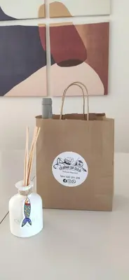 a paper bag and a tote bag with a candle at Casa Golfinho, Albufeira in Albufeira