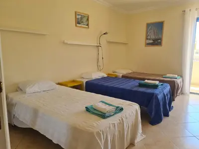 a room with two beds with blue sheets at FERIAS NA PRAIA in Albufeira