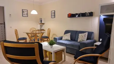 a living room with a couch and a table at FERIAS NA PRAIA in Albufeira