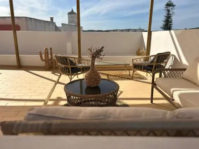a vase sitting on a table on a patio at CASA NOAVA in Loulé