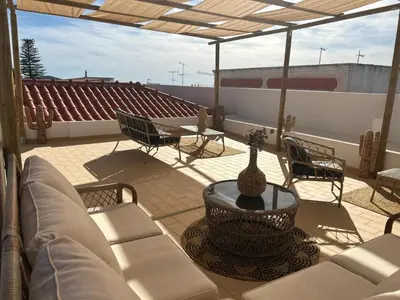 a patio with a couch and a table and chairs at CASA NOAVA in Loulé