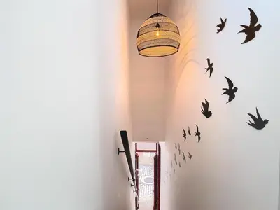 a hallway with black birds on the wall at CASA NOAVA in Loulé