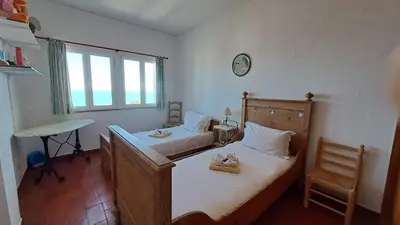 a bedroom with two beds and a desk and a window at Albufeira Seaview 4 Beach HOUSE in Albufeira