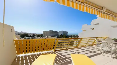 a balcony with yellow chairs and a view of the city at Al Charb TopFloor sea view, ar con, pool - CleverDetails in Vilamoura