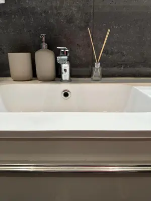a white sink with two candles on top of it at Casa Amarela in Faro