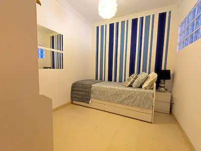 a small bedroom with a bed and a window at Lovely 2 Bedroom S Jose Apartment in Albufeira