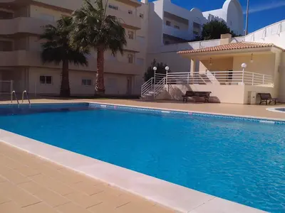 a large swimming pool in front of a building at Lovely 2 Bedroom S Jose Apartment in Albufeira