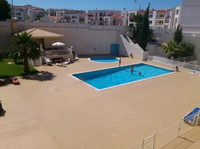 a large swimming pool with a slide in a apartment at Lovely 2 Bedroom S Jose Apartment in Albufeira