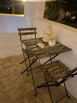 a wooden table with a lamp and a vase on it at Casa da Aldeia in Olhos de Água