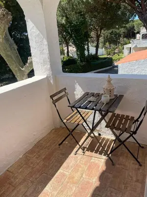 a table and two chairs sitting on a porch at Casa da Aldeia in Olhos de Água