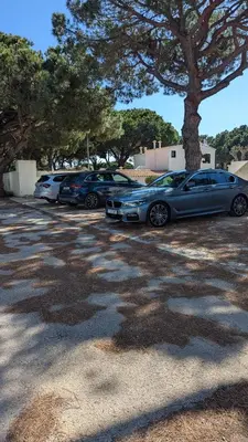 a row of cars parked in a parking lot at Casa da Aldeia in Olhos de Água