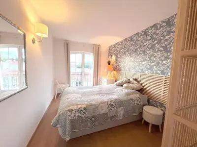 a bedroom with a bed with a blue and white blanket at Old Village, 2 bedrooms, 5 ppl, Beach, Golf, Padel in Vilamoura