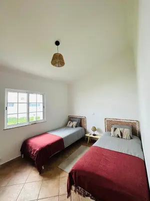 a bedroom with two beds and a window at Casa Esperança in Albufeira