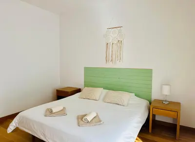a bedroom with a large bed and a window at Vila Taliéna in Albufeira