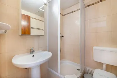 a bedroom with a white bed and a large window at Family Holidays @ Caminho do Lago in Quarteira