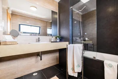 a bathroom with a sink and a shower at Villas Novochoro - Small Garden by DreamvillasAlbufeira in Albufeira