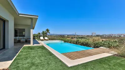 a swimming pool in the backyard of a house at Brand New Waterfront Villa with pool in Faro