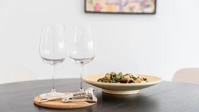 a table with two wine glasses and a plate of food at Modern Retreat 2 in Faro by Lovelystay in Faro