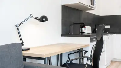 a desk in a kitchen with a lamp and chairs at Modern Retreat 2 in Faro by Lovelystay in Faro