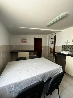 a bedroom with a large bed with chairs in it at O Limoeiro - 154949/AL in Faro