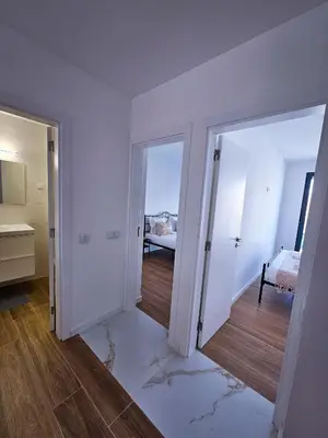 an empty room with two sliding doors and a bedroom at Carmo City Center 2 in Faro