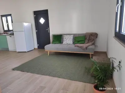 a living room with a couch and a table at Casa do Belé in Faro