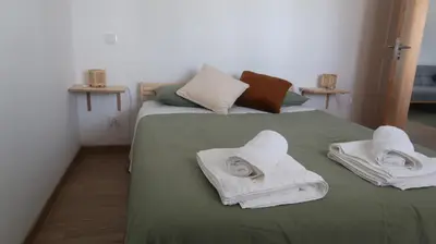 a kitchen with green cabinets and a washing machine at Casa do Belé in Faro