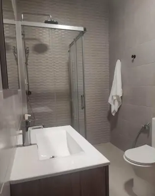 a bathroom with a sink and a shower and a toilet at Casa do Belé in Faro