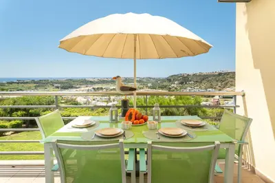 an aerial view of a city with colorful buildings at BnB Homes Ocean view Apartment with comfortable Terrace, 2 Swimming pools & Tennis court in Albufeira