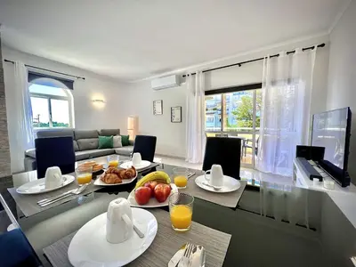 a living room with a table with food on it at Albufeira Marina Sol With Pool by Homing in Albufeira