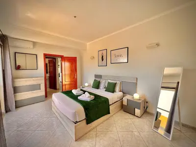 a bedroom with a bed and a mirror in it at Albufeira Marina Sol With Pool by Homing in Albufeira