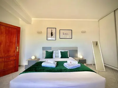 a bedroom with a large bed with two towels on it at Albufeira Marina Sol With Pool by Homing in Albufeira