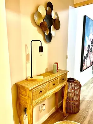 a wooden table with a lamp and plates on the wall at Casa da vila in Faro