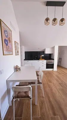 a kitchen and dining room with a table and chairs at Carmo City Center 3 in Faro