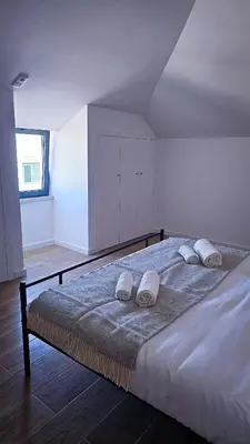 a bedroom with a bed with two pillows on it at Carmo City Center 3 in Faro