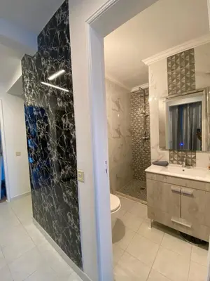 a bathroom with a shower and a toilet and a sink at Casa eden garden in Albufeira