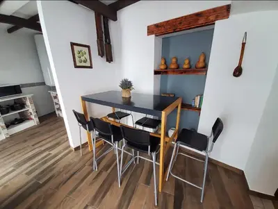 a dining room with a blue table and chairs at Blife Castelya private rooms in Faro