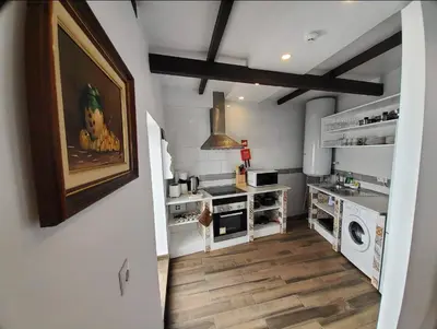 a kitchen with a sink and a washing machine at Blife Castelya private rooms in Faro