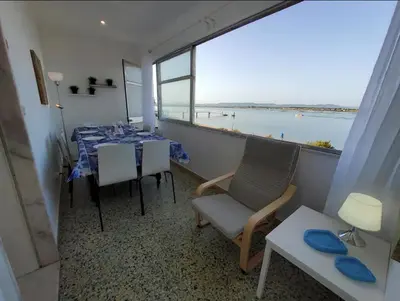 a dining room with a table and a view of the ocean at Blife Faya private rooms in Faro