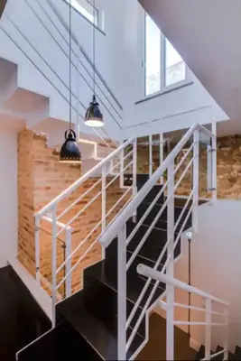a staircase in a house with white rails and windows at Blife Frankya private rooms in Faro