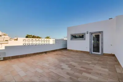 a large white house with a balcony at Blife Frankya private rooms in Faro