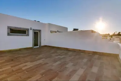 an empty room with white walls and wooden floors at Blife Frankya private rooms in Faro